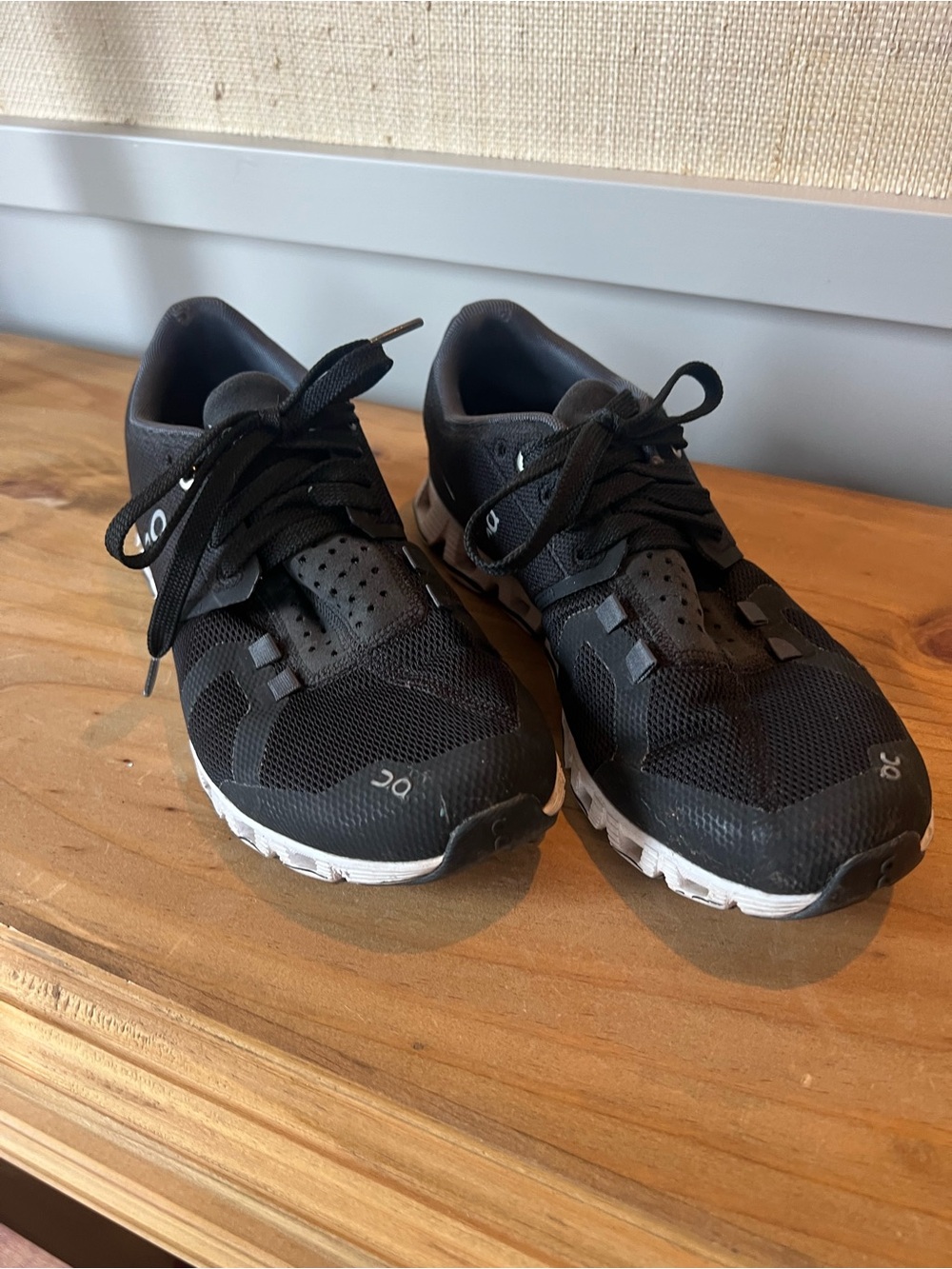 On Running Black Athletic Shoes with White Soles and Subtle Gray Accents